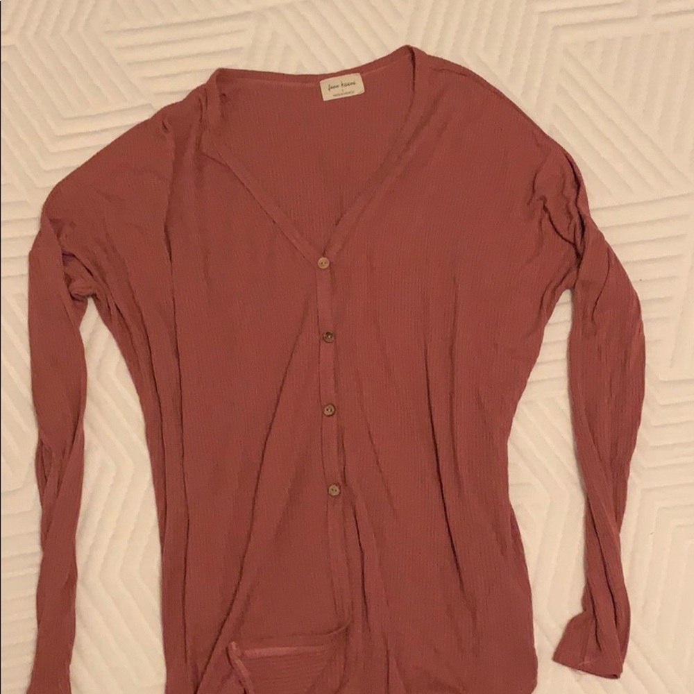 Long sleeve shirt with buttons attached to it